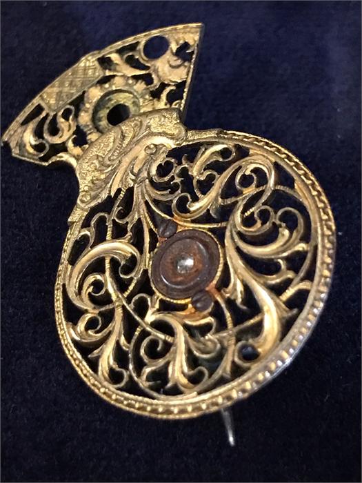 A Victorian brooch comprising a Georgian gilt metal verge pocket watch balance cock set with a