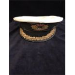 A 1960's Royal Navy Captain's Hat with gold braid and original 'Gieves' label to the inside