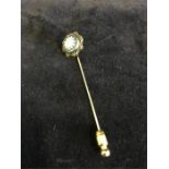 A 9ct gold lapel pin with a jasperware daisy inset