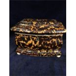An Antique Tortoiseshell tea caddy with a musical box in the lid