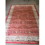 A red ground cashmere rug with unique all over design and cream border 2.4m x 2.6m