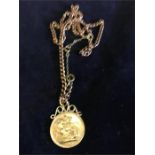 A 1963 gold sovereign on a gold mount on a 9ct gold chain (21.6g total)