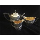 A Three piece silver tea service to include teapot, milk jug, and sugar bowl hallmarked Sheffield