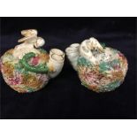 A pair of Antique Staffordshire inkwells depicting a bird protecting her eggs from a serpent