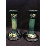 A pair of circa 1916 Moorcroft candlesticks signed.