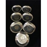 Seven silver dishes with central coin insets made in Hong Kong, total weight (394g)