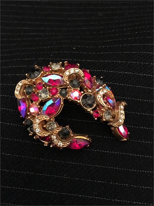 A Brooch with a Harlequin array of coloured stones