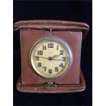 A Doxa travel clock in a leather case