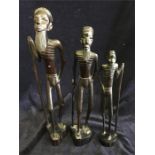 Three graduated in height carved African figures