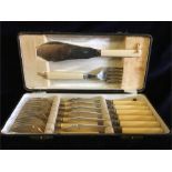 A cased box of six fish knives and forks along with serving knife and fork