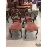 A set of four balloon back mahogany dining chairs