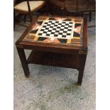 A marble topped With chess board table in oak