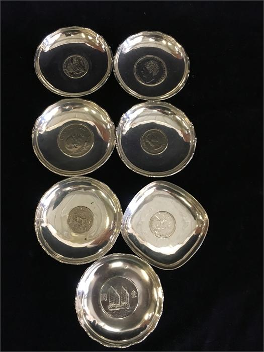 Seven silver dishes with central coin insets made in Hong Kong, total weight (394g) - Image 2 of 2