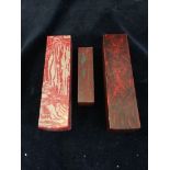 Three red soapstone blocks