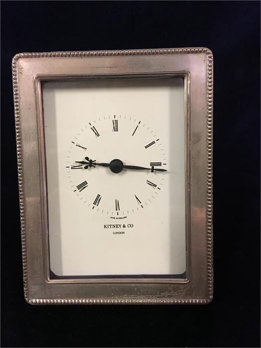 A Kitney & Co silver framed clock