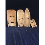 Four carved African masks
