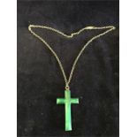 A silver cross with agate inset