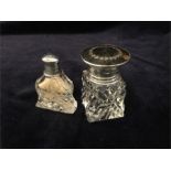 Two scent bottles one with a silver top and one with a tortoiseshell and silver lid