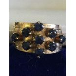 An 18ct gold ring with sapphires Total weight 5.6g