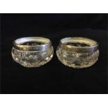 A pair of hallmarked silver rimmed glass mustards