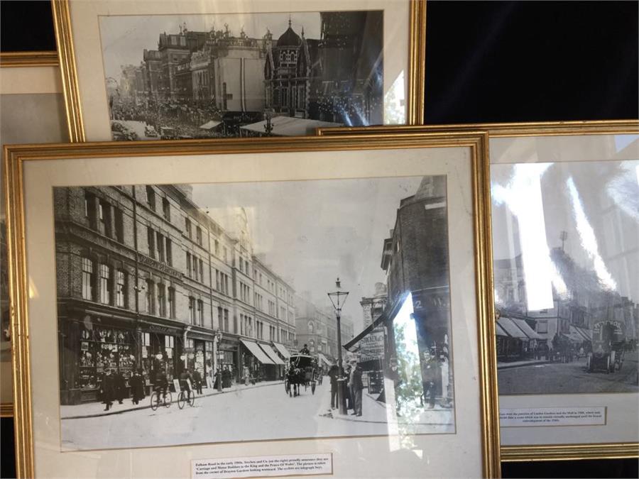 Four framed black and white photographs of London scenes.