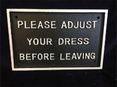 A Cast Iron Please Adjust Your Dress Sign