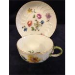 A mid 18th Century Meissen tea cup and saucer with a floral design.