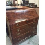 A Mahogany bureau with brass handles and fitments