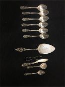 A volume of Dutch silver to include spoons, sugar nips, cake slice (Total weight 299.3g)