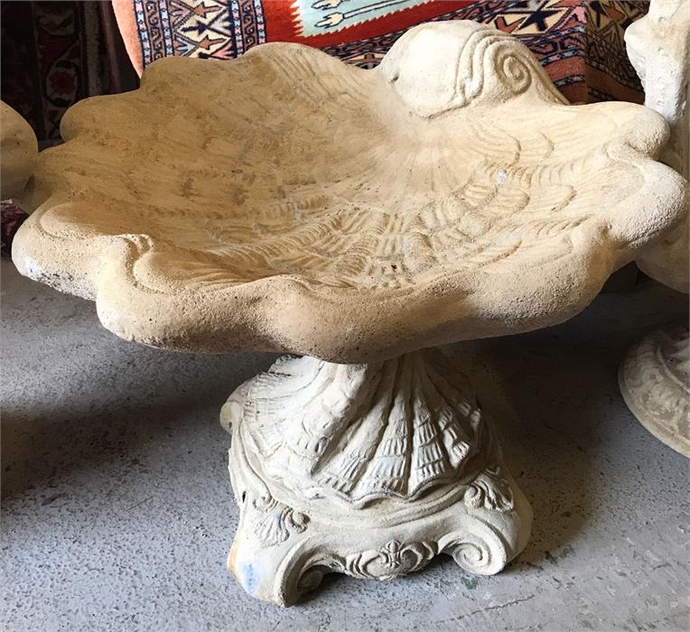 A garden stoneware shell bird bath