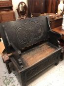 A Monks bench with carved Coat of Arms