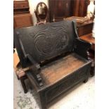 A Monks bench with carved Coat of Arms