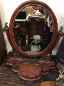 A Mahogany toilet mirror with storage in stand