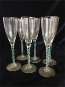 A set of six opaque and green twisted stem champagne flutes.