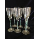 A set of six opaque and green twisted stem champagne flutes.