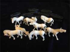 A herd of worked ivory horses on stands