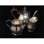 A Silver tea set to include teapot, sugar bowl and milk jug hallmarked Sheffield 1962, makers mark R