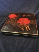 A Lacquered box with a floral design.