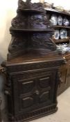 A Belgian oak corner cabinet