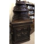 A Belgian oak corner cabinet