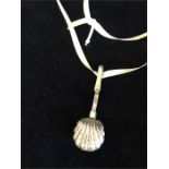 A silver shell style necklace on ribbon