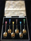 A Boxed set of silver and enamel teaspoons, Harrods.