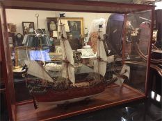 A scale model of VASA, the Kings Ship and supporting book in a glass case.