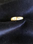 An 18ct gold ring (3.3g), missing stones.