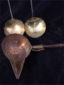 Two antique ladles in brass and a copper pourer