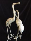 A pair of metal decorative cranes