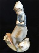 A Lladro figurine of a lady with a goose and goslings in basket