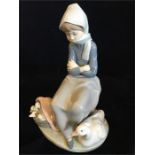 A Lladro figurine of a lady with a goose and goslings in basket