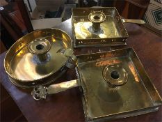 Three antique brass candlestick holders.