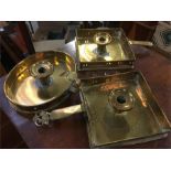 Three antique brass candlestick holders.